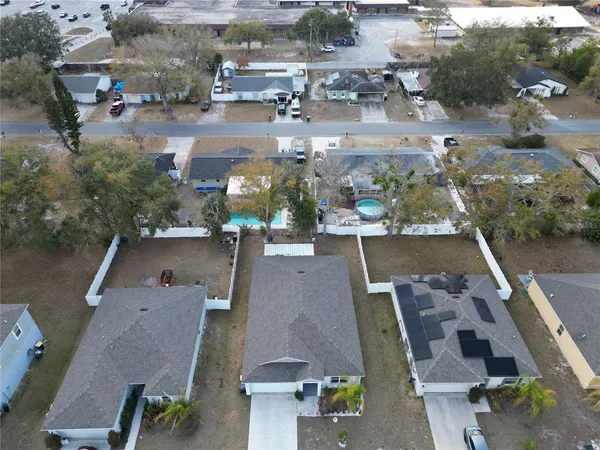 an aerial view of residential houses with outdoor space