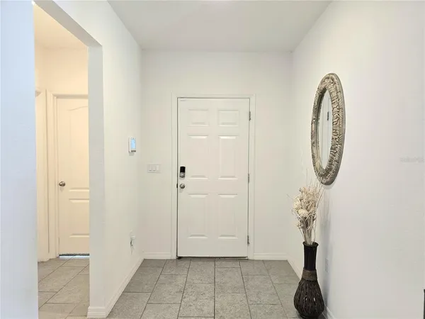 a view of a room with wooden floor and entryway
