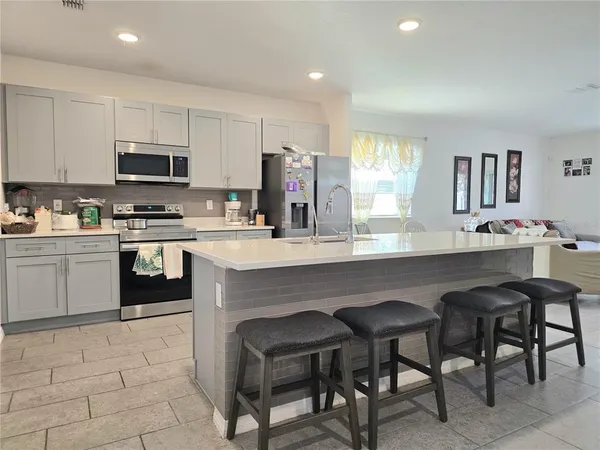 a kitchen with a sink cabinets and window