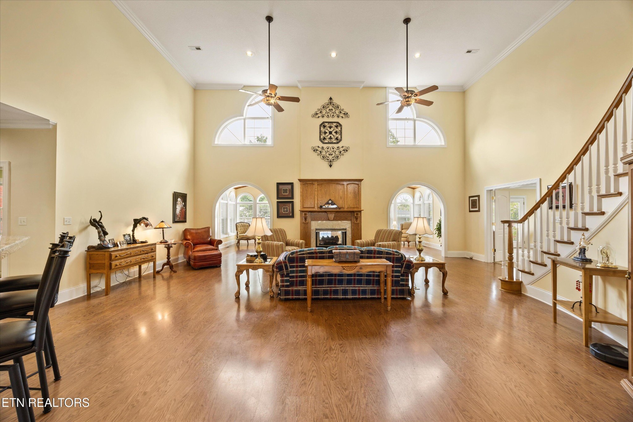 132 David Road Clinton, TN 37716 - Photo 16 of 52 a living room with couches chairs and kitchen view with wooden floor