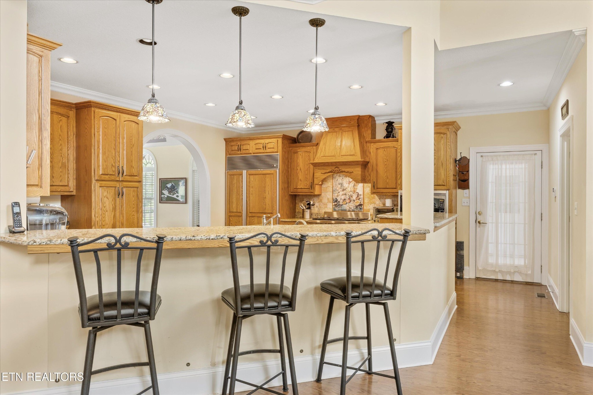 132 David Road Clinton, TN 37716 - Photo 24 of 52 a view of a dining room and livingroom with furniture wooden floor a chandelier