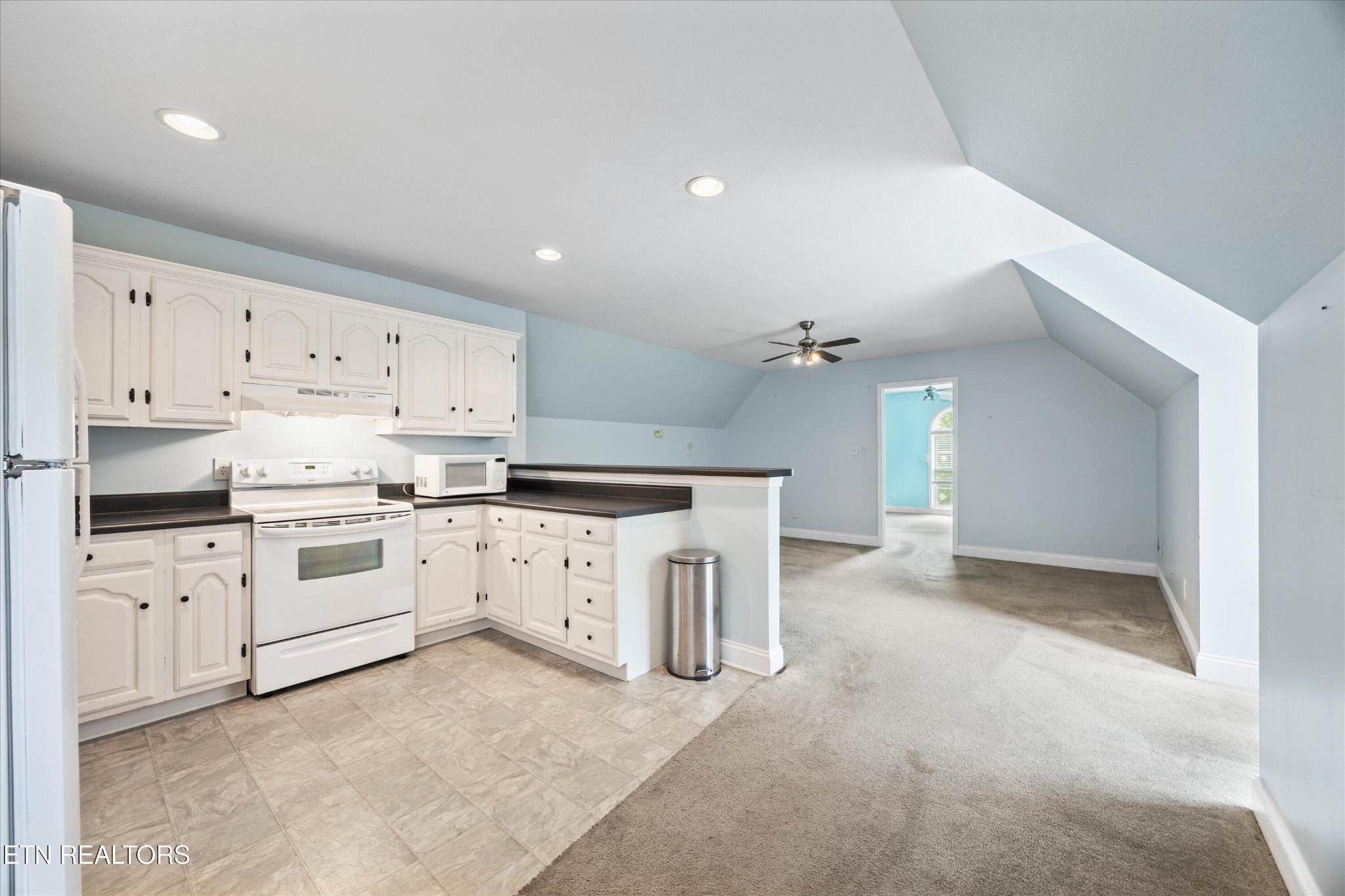 132 David Road Clinton, TN 37716 - Photo 49 of 52 a kitchen with white cabinets and white appliances