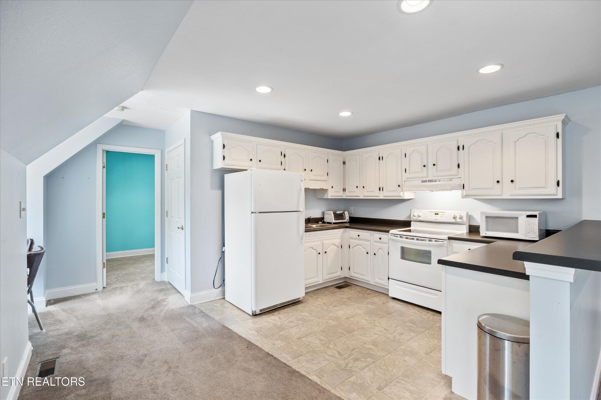 132 David Road Clinton, TN 37716 - Photo 50 of 52 a kitchen with white cabinets and white appliances