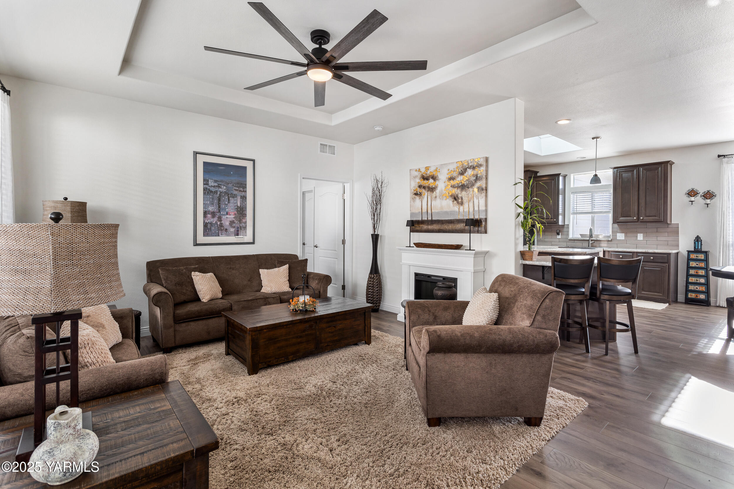 200 Bridle Way, Unit 177 Yakima, WA 98901 - Photo 11 of 37 a living room with furniture a fireplace and a flat screen tv