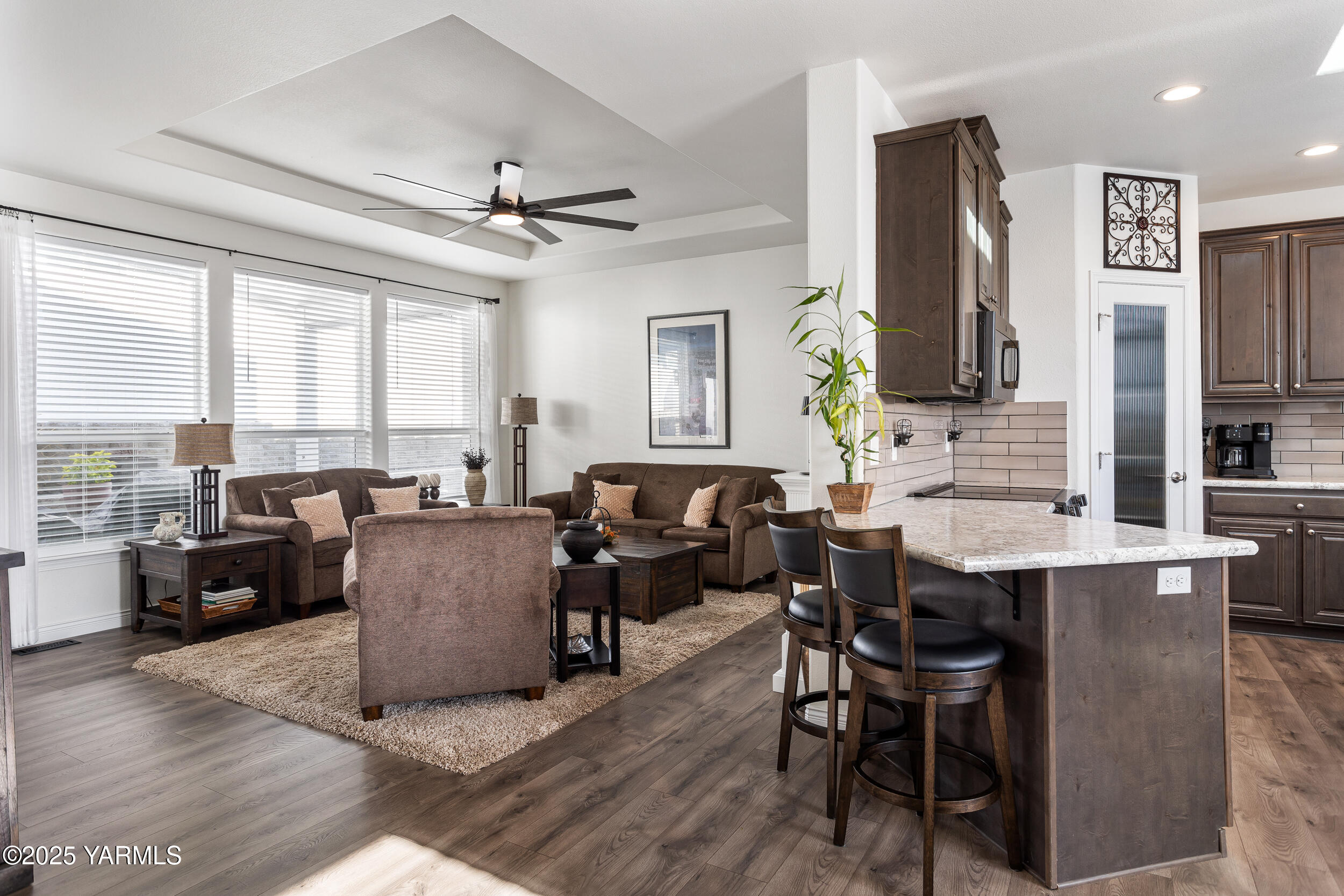 200 Bridle Way, Unit 177 Yakima, WA 98901 - Photo 10 of 37 a living room with furniture a large window and a chandelier