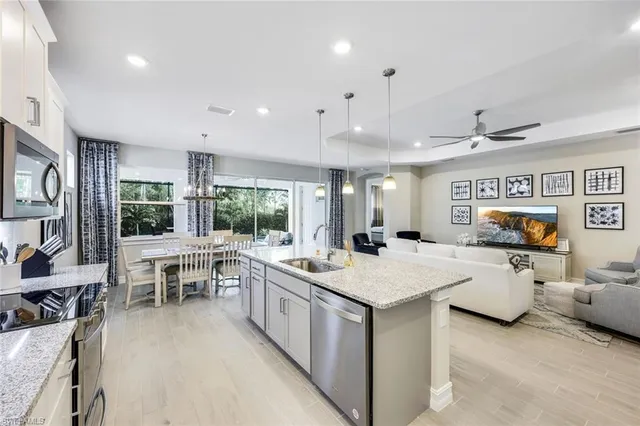 a large white kitchen with a large window