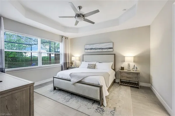 a bedroom with a large bed and a chandelier