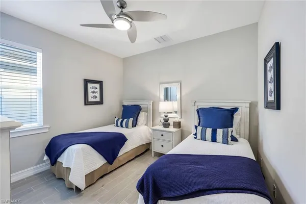 a bedroom with two beds and a window