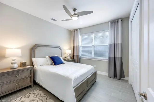 a bedroom with a large bed and a window