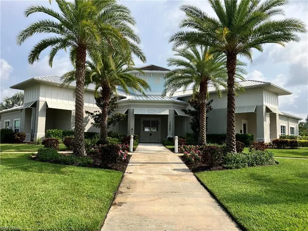 a front view of a house with a garden and patio