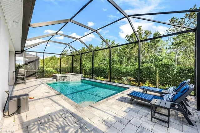 a patio with yard glass top table and chairs