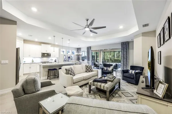a living room with furniture ceiling fan and a window