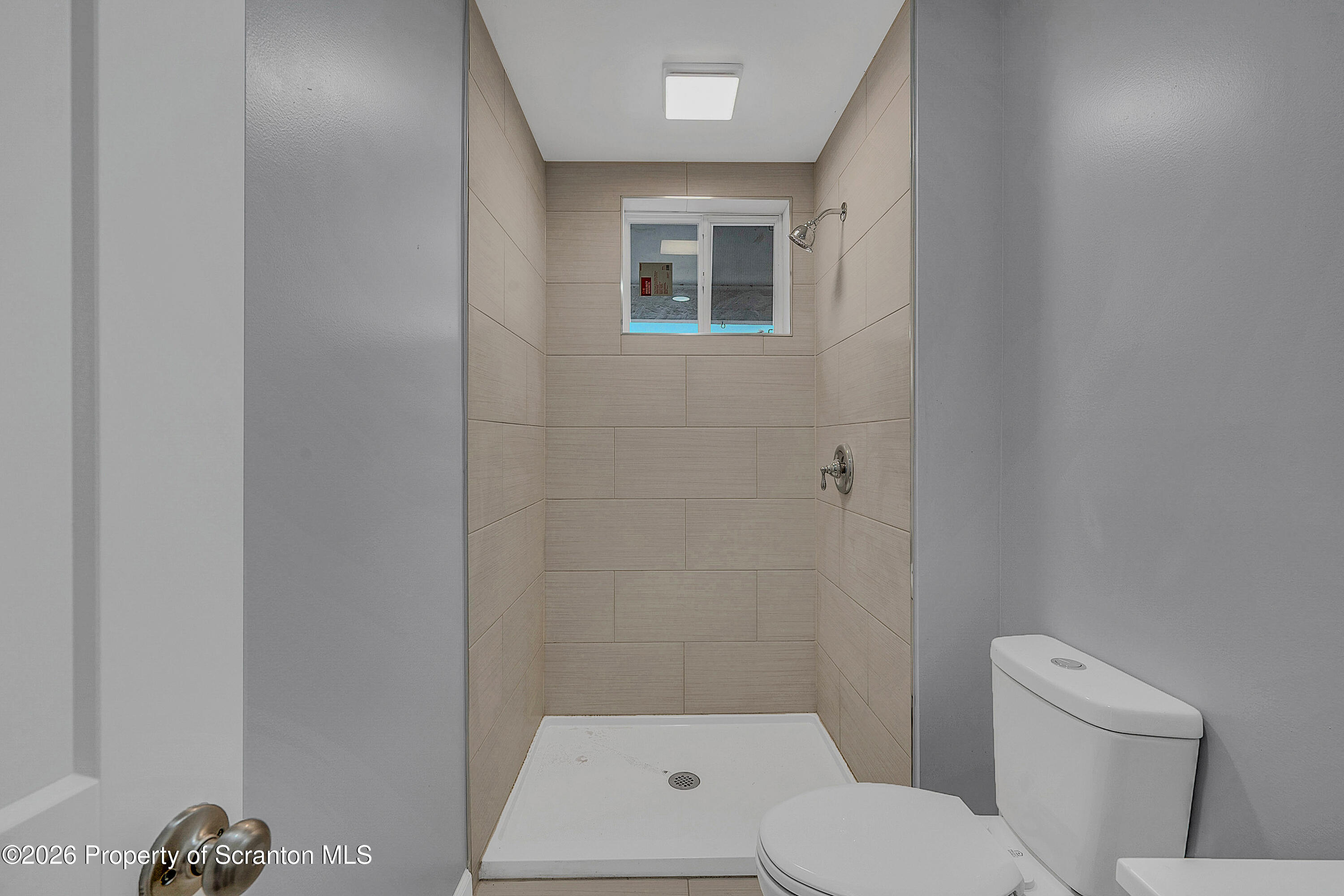 6 Green Ridge Street, Unit 2 Scranton, PA 18509 - Photo 11 of 20 a white toilet sitting next to a shower