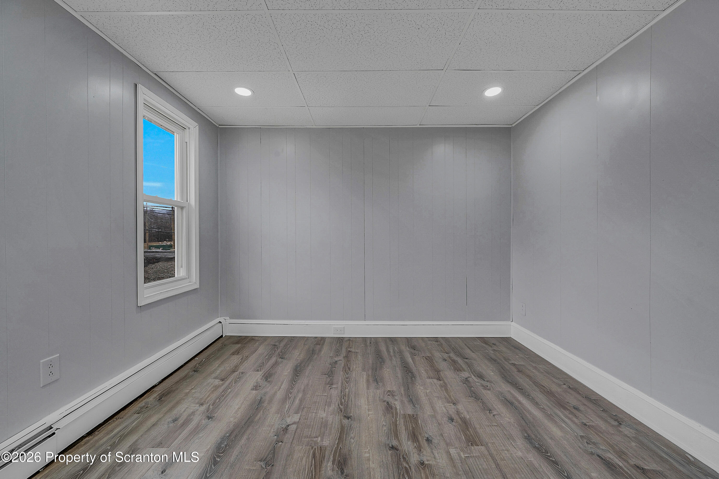 6 Green Ridge Street, Unit 2 Scranton, PA 18509 - Photo 14 of 20 a view of an empty room with wooden floor and a window