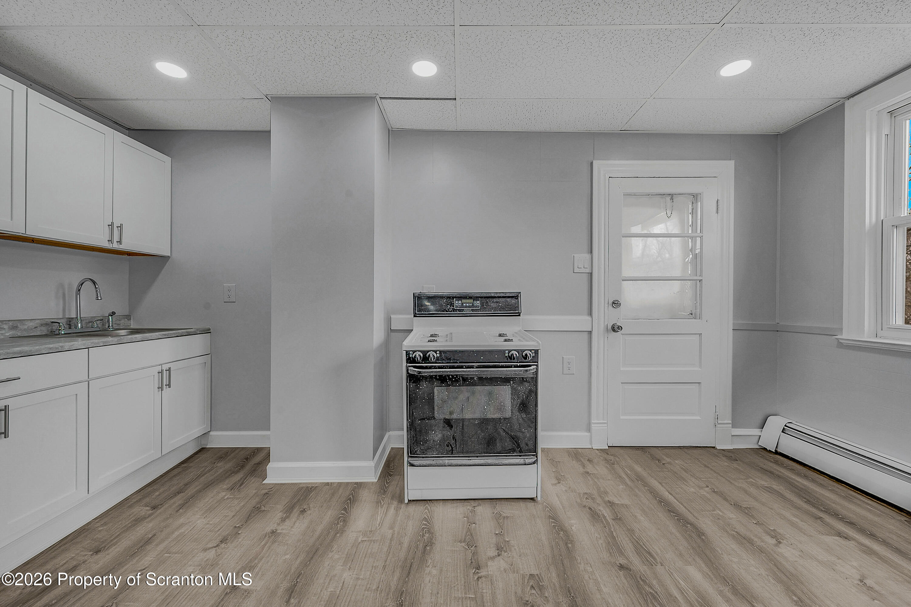 6 Green Ridge Street, Unit 2 Scranton, PA 18509 - Photo 16 of 20 a kitchen with granite countertop a stove cabinets and wooden floor
