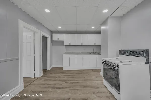 a kitchen with a stove top oven sink and cabinets