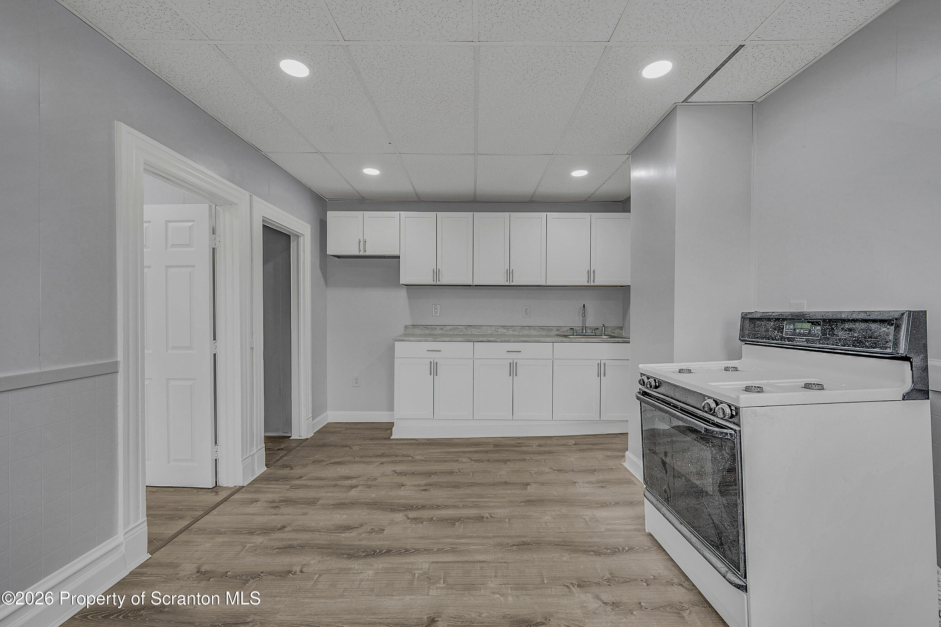 6 Green Ridge Street, Unit 2 Scranton, PA 18509 - Photo 18 of 20 a kitchen with a stove top oven sink and cabinets