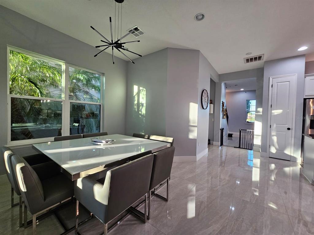 8552 Powder Ridge Trail Windermere, FL 34786 - Photo 12 of 39 a dining room with furniture and window