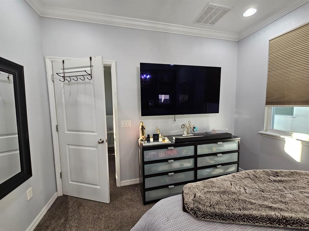 8552 Powder Ridge Trail Windermere, FL 34786 - Photo 13 of 39 a living room with a bed furniture and a flat screen tv