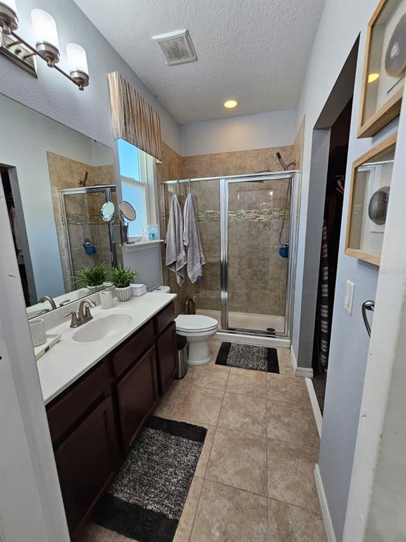 8552 Powder Ridge Trail Windermere, FL 34786 - Photo 16 of 39 a bathroom with a double vanity sink toilet and shower