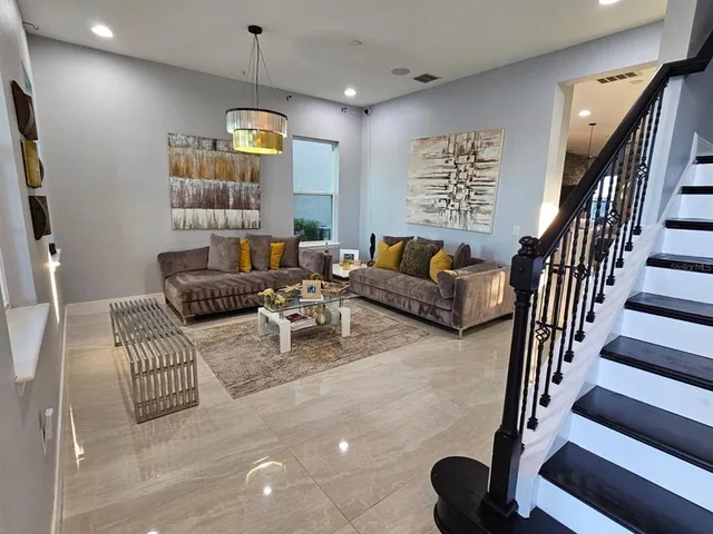 a living room with furniture fireplace and rug