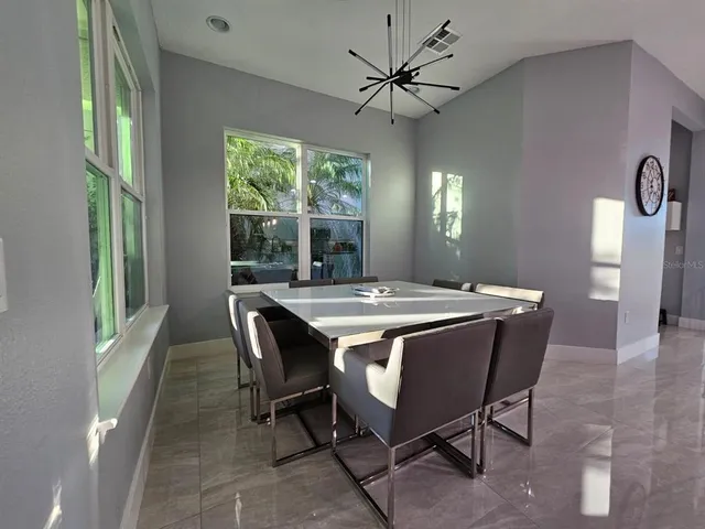 a view of a dining room with furniture window and outside view