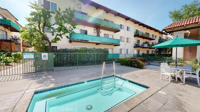 a view of a patio with a table and chairs under an umbrella