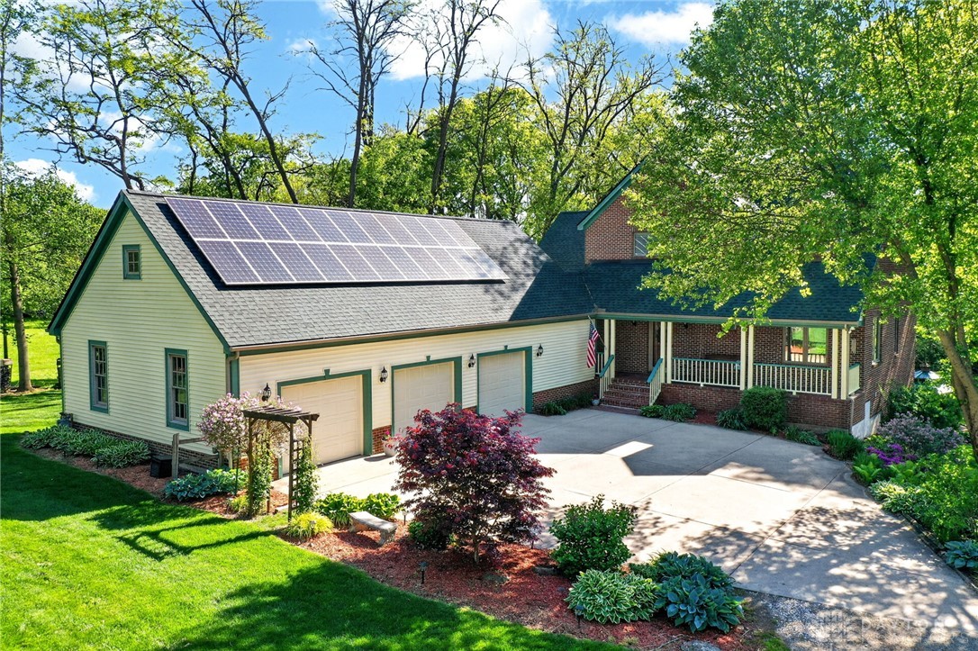 330 South Alpha Bellbrook Road Bellbrook, OH 45305 - Photo 65 of 87 This charming residence features solar panels and a welcoming porch, nestled within lush landscaping.