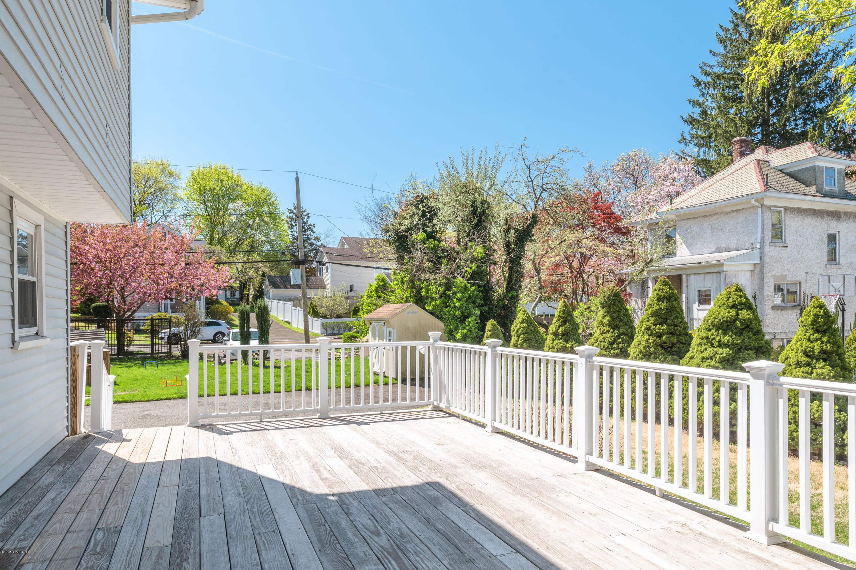 10 Oxer Place Greenwich, CT 06830 - Photo 20 of 22 a view of a house with a wooden fence