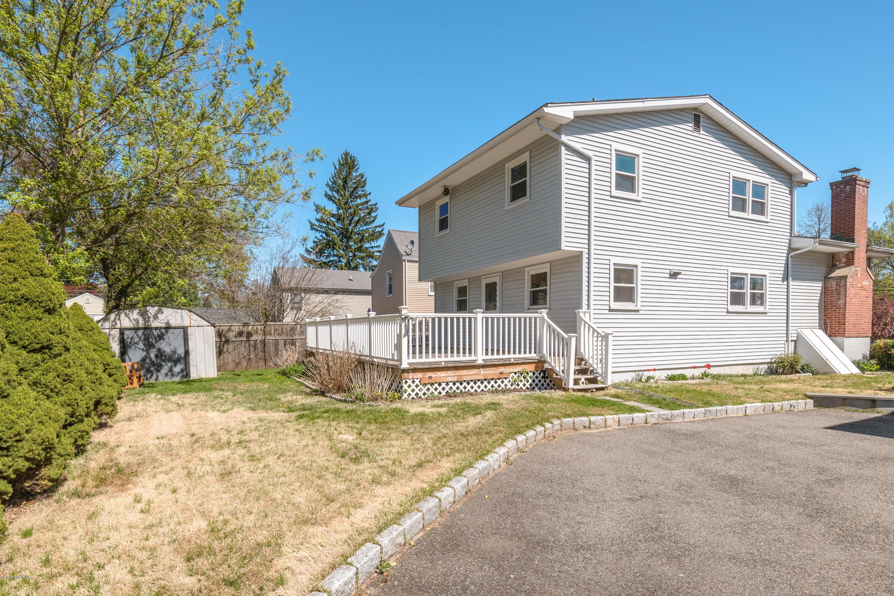 10 Oxer Place Greenwich, CT 06830 - Photo 22 of 22 a front view of a house with a yard