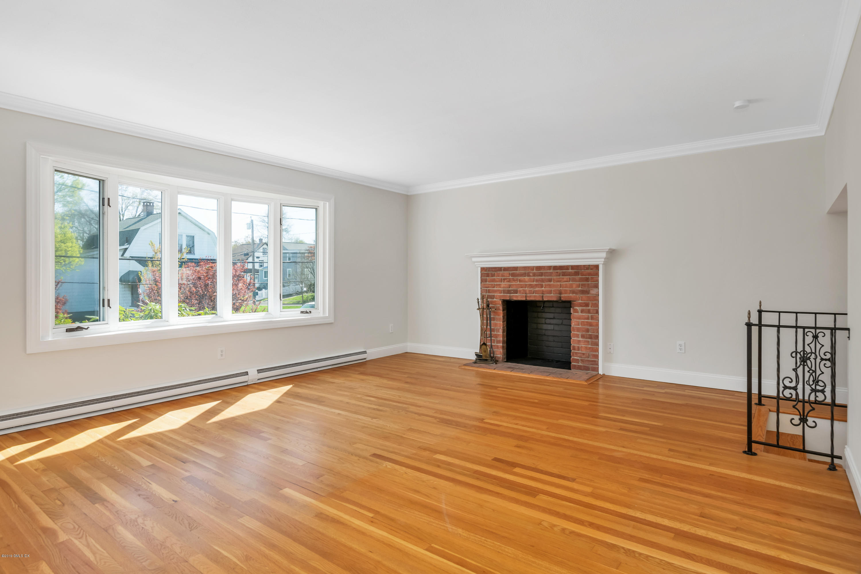10 Oxer Place Greenwich, CT 06830 - Photo 3 of 22 a view of an empty room with window and wooden floor