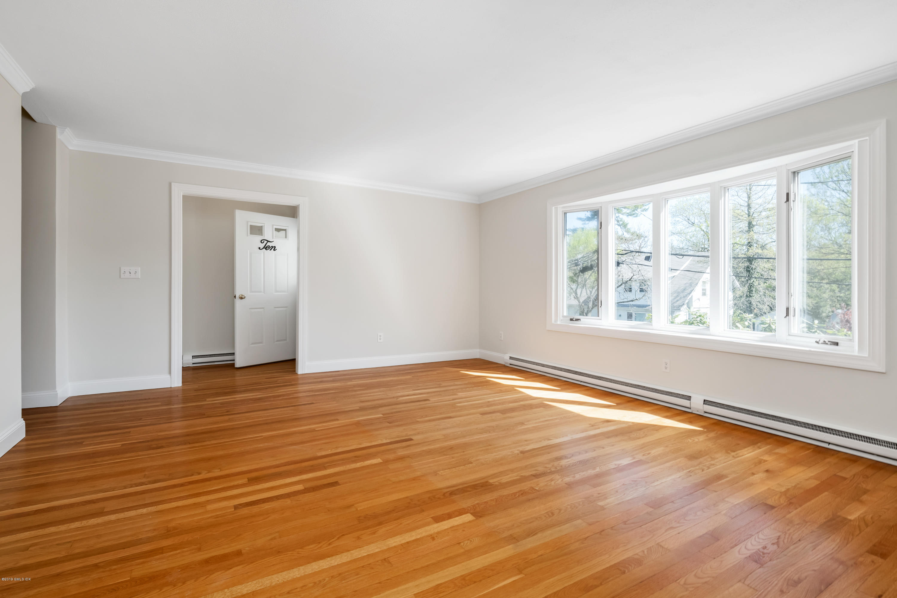 10 Oxer Place Greenwich, CT 06830 - Photo 4 of 22 a view of an empty room with wooden floor and a window