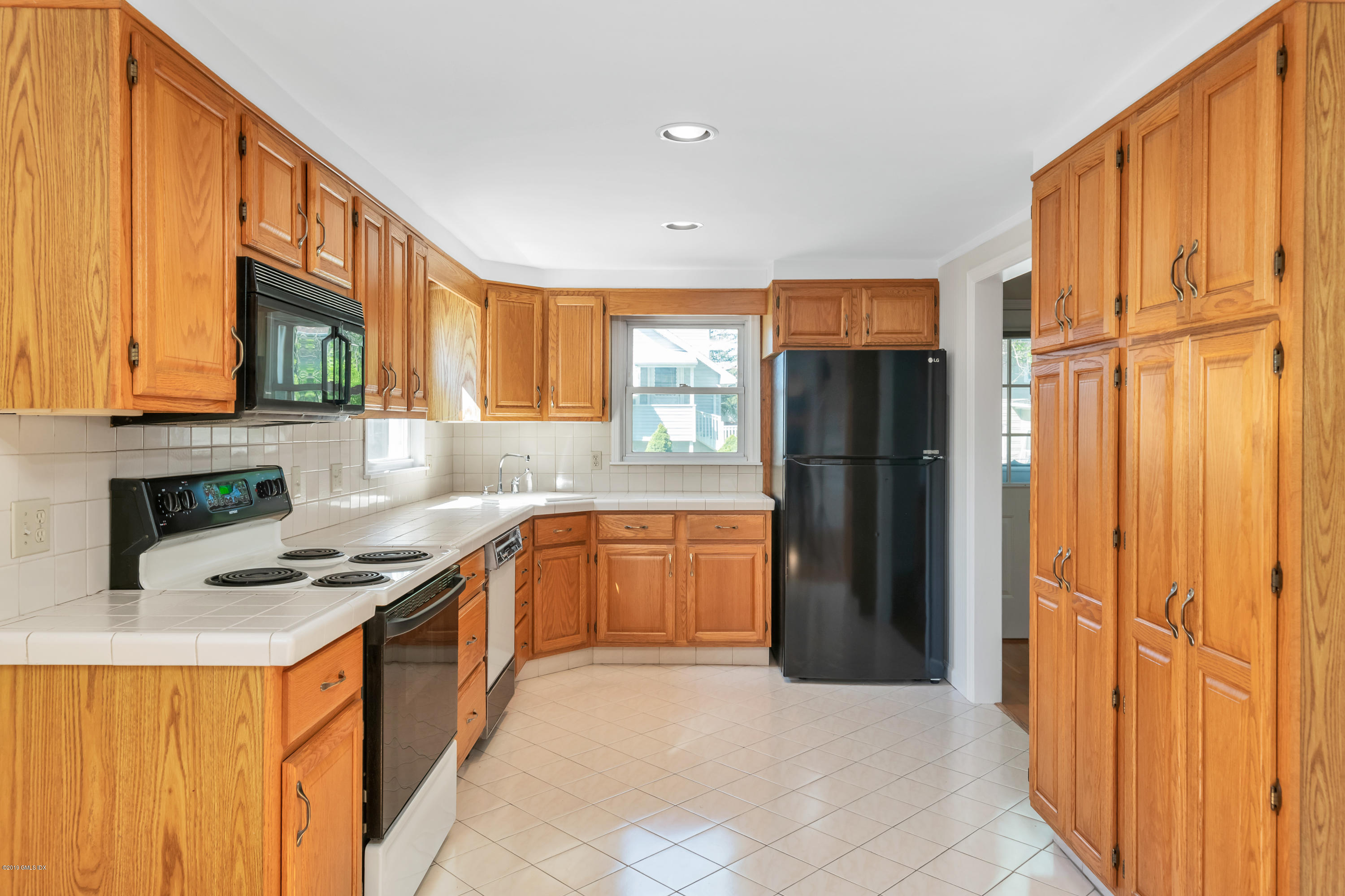 10 Oxer Place Greenwich, CT 06830 - Photo 6 of 22 a kitchen with stainless steel appliances granite countertop a refrigerator and a stove top oven