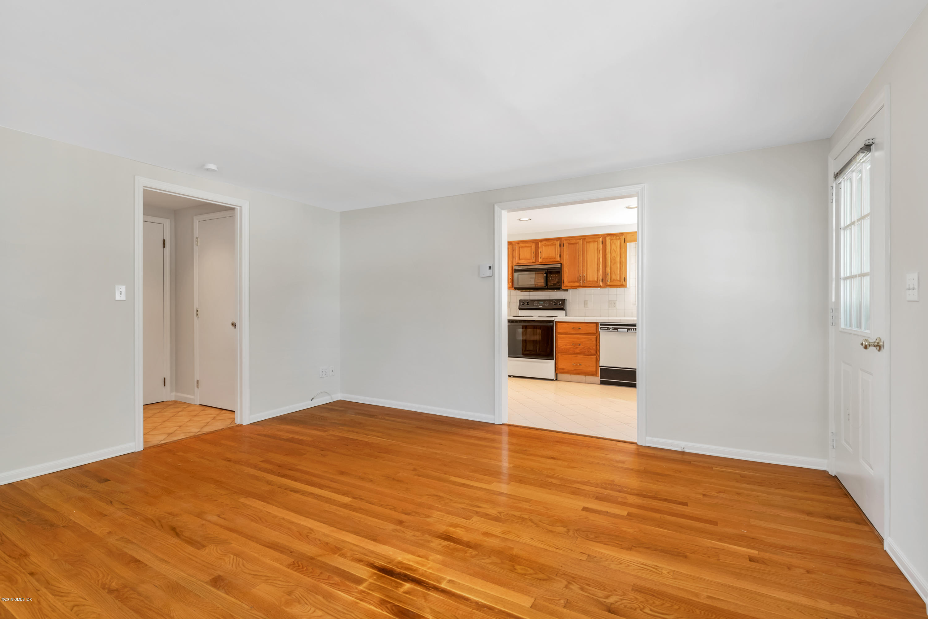 10 Oxer Place Greenwich, CT 06830 - Photo 10 of 22 a view of empty room with wooden floor and fan