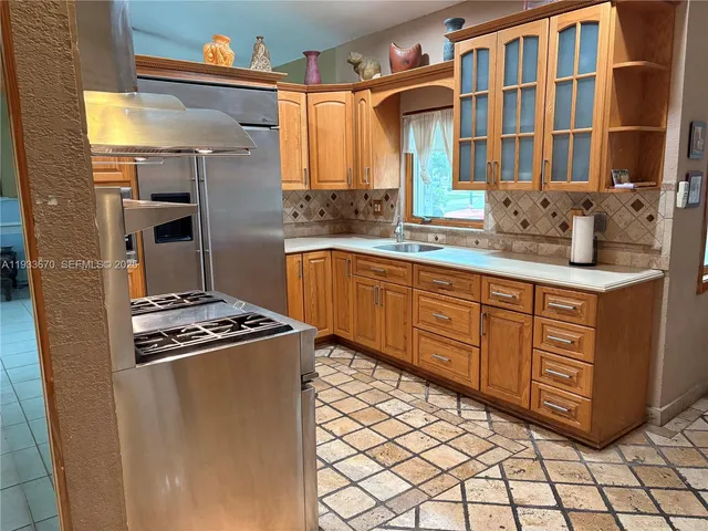 a kitchen with stainless steel appliances granite countertop a stove and a sink