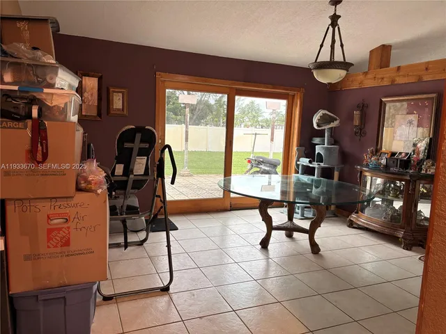 a living room filled with furniture and a chandelier