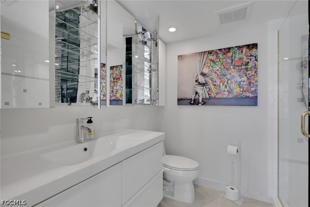 9 High Point Circle North, Unit 101 Naples, FL 34103 - Photo 23 of 49 a bathroom with a toilet sink and tub