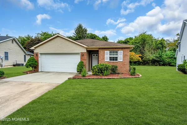 a front view of house with yard and green space