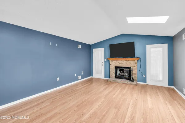 a view of an empty room with a fireplace