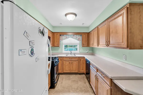 a kitchen with a sink a stove and cabinets