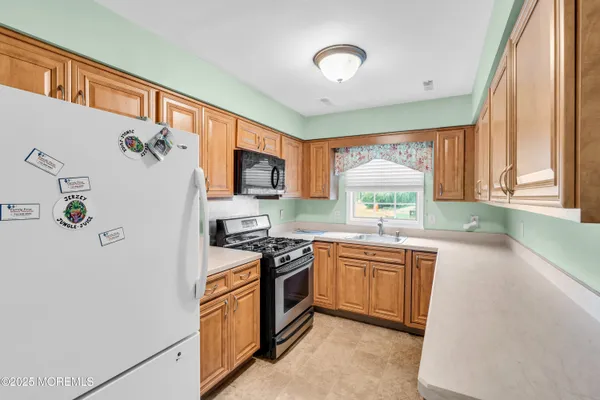 a kitchen with a refrigerator stove and sink