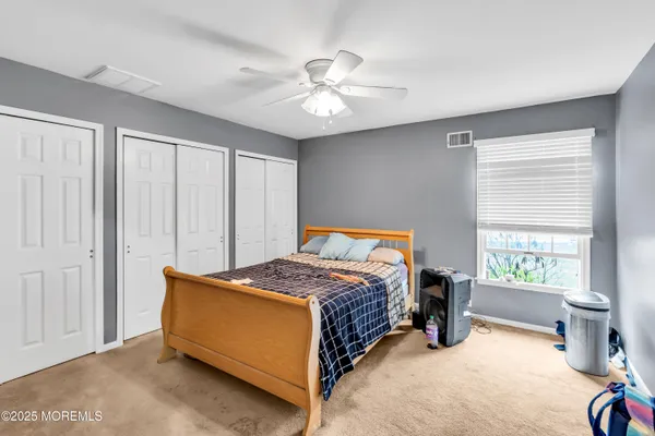 a bed room with a bed and a window