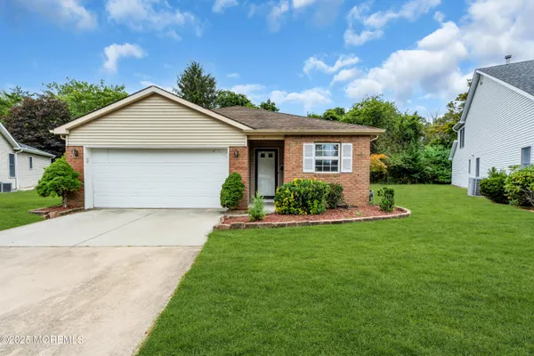 a front view of house with yard and green space