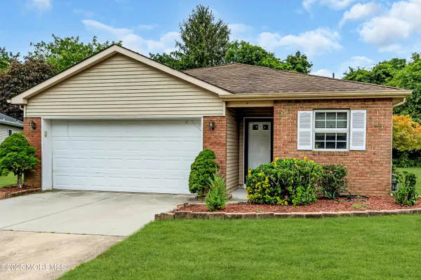 a view of a house with a yard and plants