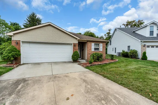 a front view of house with garage and yard