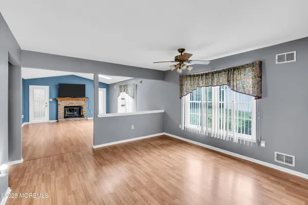 wooden floor in an empty room with a window