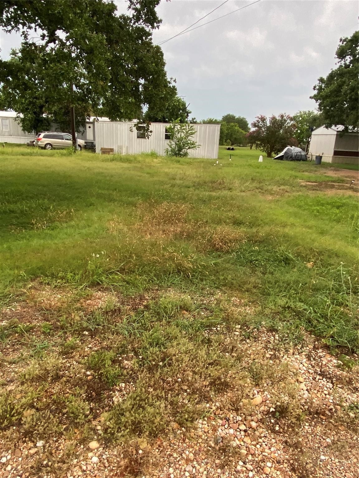 406 Fordtrant Ellinger, TX 78938 - Photo 10 of 17 a view of yard with green space and trees all around