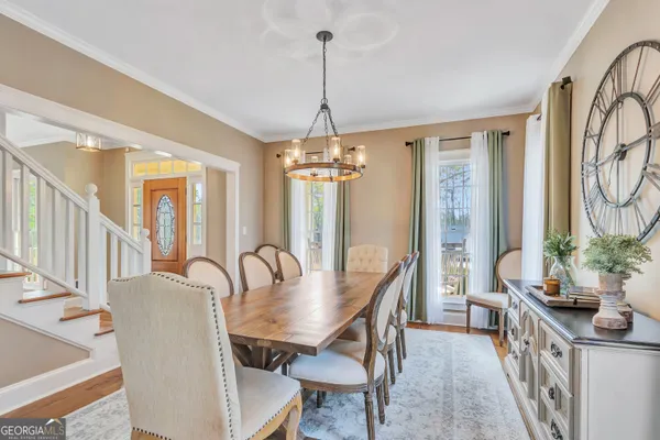 a kitchen with stainless steel appliances granite countertop wooden floor window and white cabinets