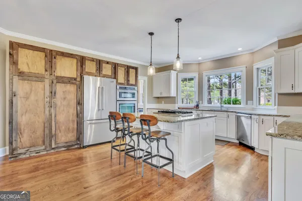 a kitchen with a counter top space appliances and cabinets