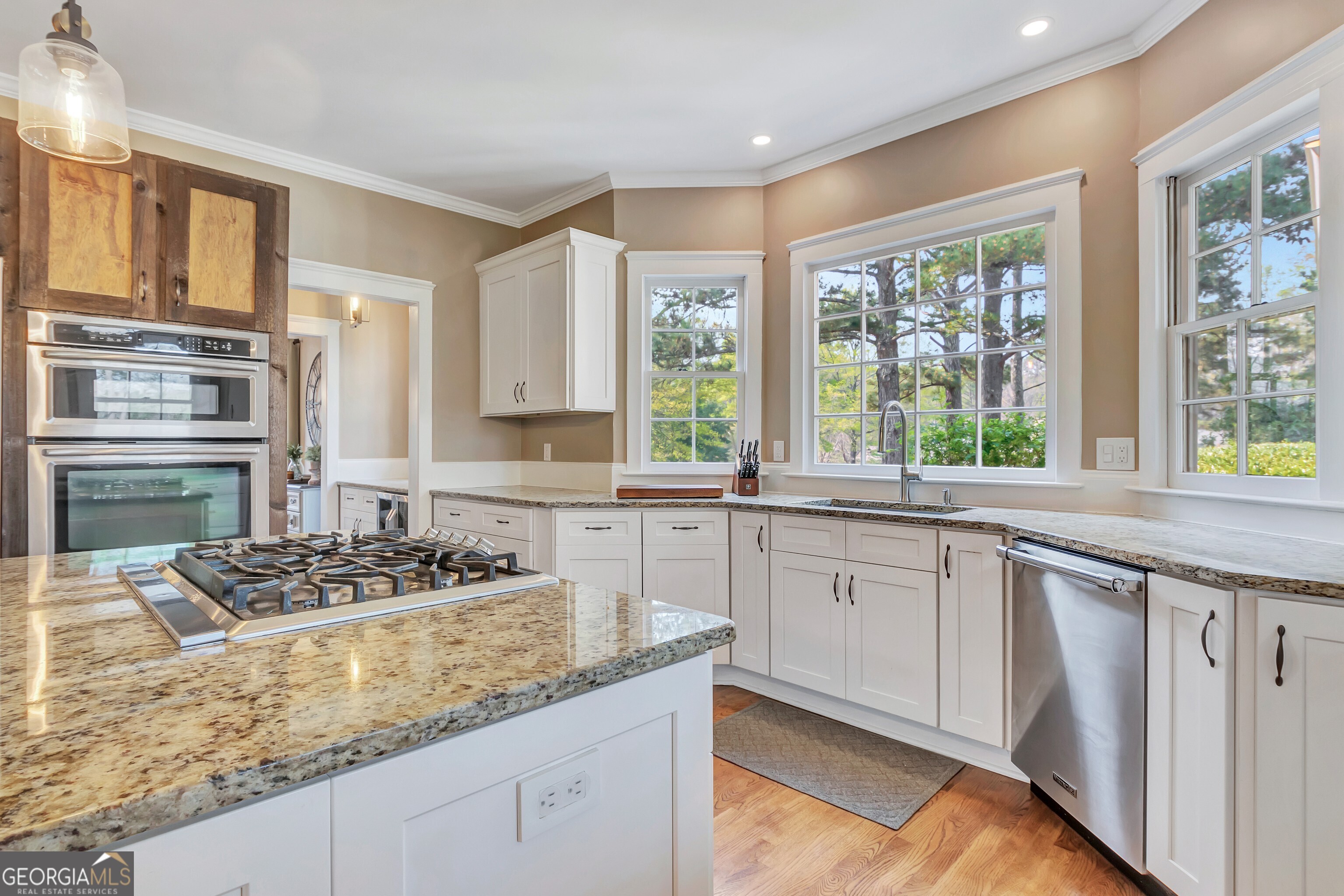 388 Swanson Road Tyrone, GA 30290 - Photo 20 of 62 a kitchen with stainless steel appliances granite countertop a stove a sink and a granite counter tops with wooden floors
